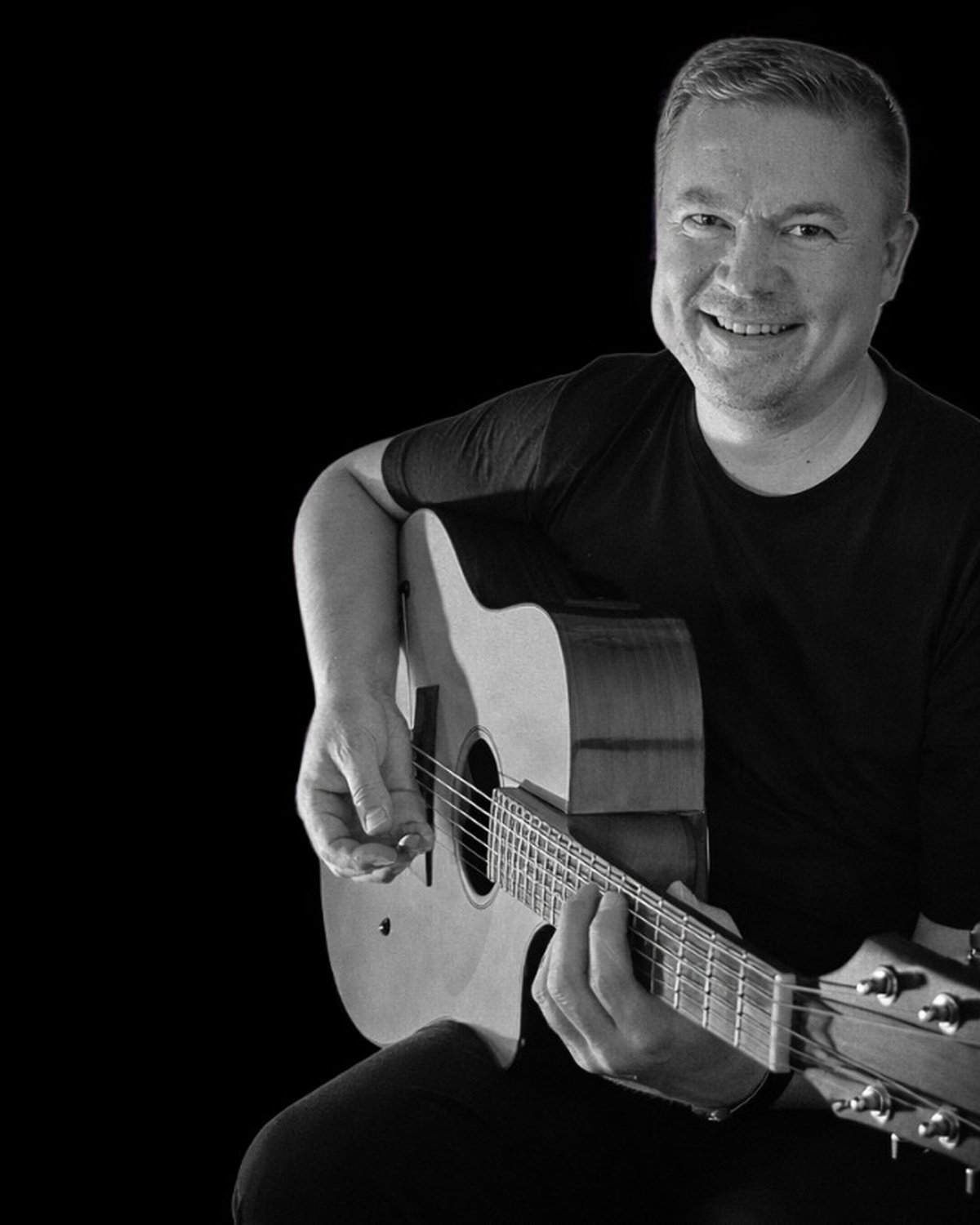 Juha Granberg with an acoustic guitar